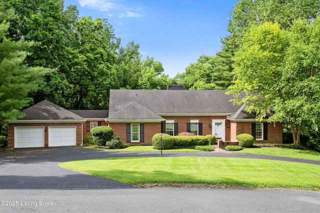 602 Club Ln, Louisville, KY 40207 - view of front facade with asphalt driveway, brick siding, a front lawn, and an attached garage