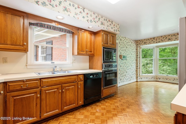 602 Club Ln, Louisville, KY 40207 - kitchen with black appliances, wallpapered walls, brown cabinets, and light countertops