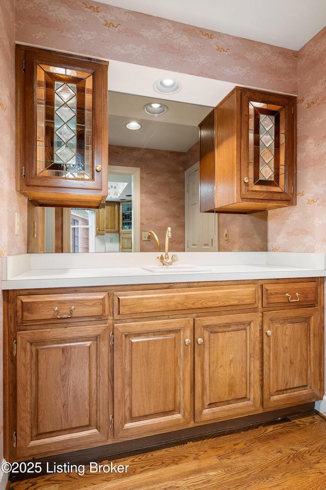 602 Club Ln, Louisville, KY 40207 - kitchen featuring wallpapered walls, light countertops, recessed lighting, wood finished floors, and brown cabinetry