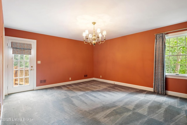602 Club Ln, Louisville, KY 40207 - carpeted empty room featuring healthy amount of natural light and a chandelier