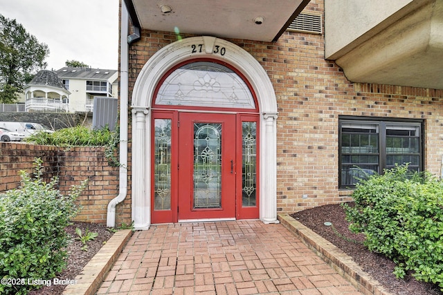 entrance to property with brick siding