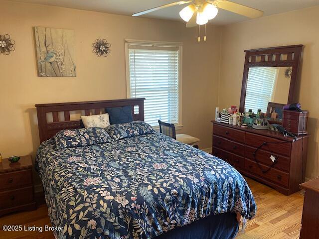 bedroom featuring ceiling fan and wood finished floors