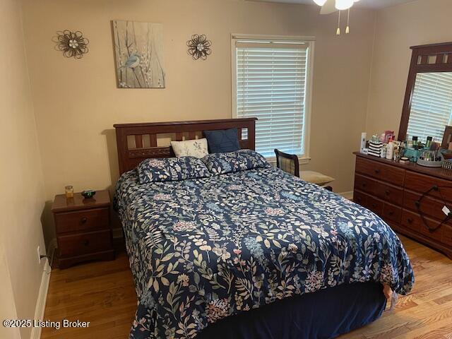 bedroom with wood finished floors and baseboards