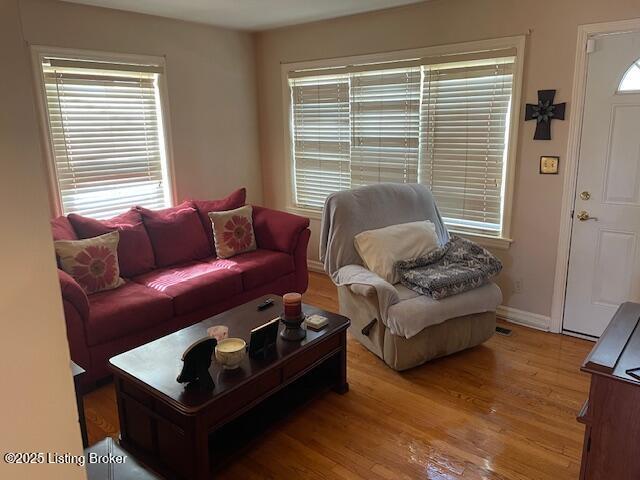 living room featuring light wood finished floors and baseboards