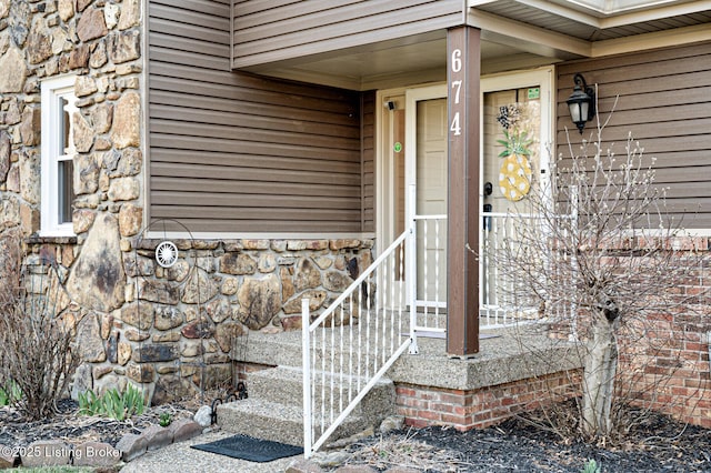 entrance to property featuring stone siding