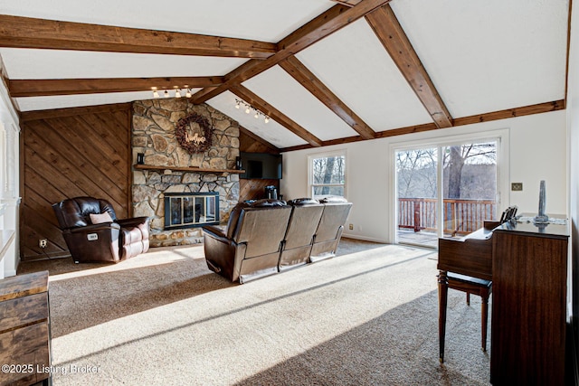 living area with carpet flooring, a fireplace, vaulted ceiling with beams, and wooden walls