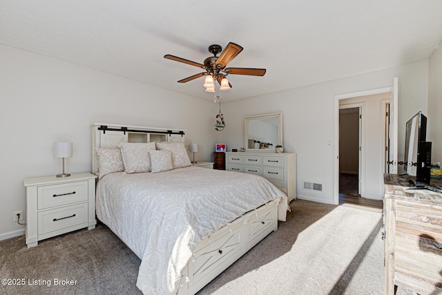 bedroom featuring a ceiling fan, baseboards, visible vents, and dark colored carpet