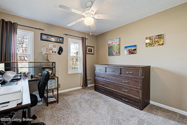 carpeted home office with baseboards, plenty of natural light, and a ceiling fan