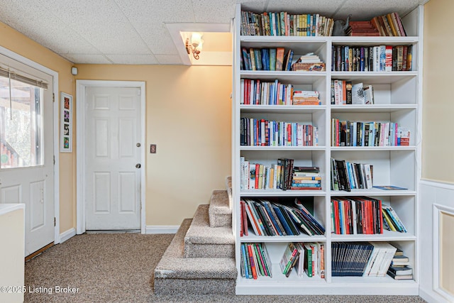 sitting room with a paneled ceiling, baseboards, and carpet floors