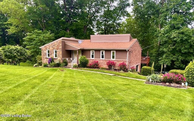 view of front of property with stone siding and a front yard