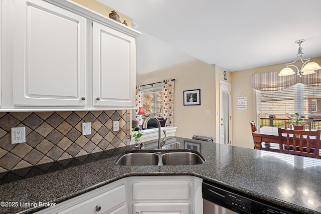 kitchen featuring backsplash, white cabinets, stainless steel dishwasher, and a sink