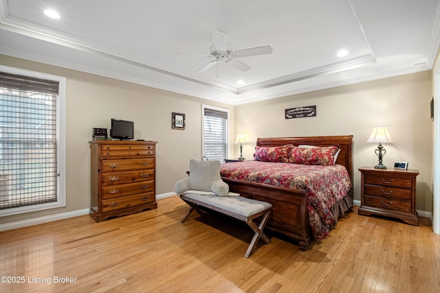 bedroom with crown molding, baseboards, a tray ceiling, recessed lighting, and wood finished floors