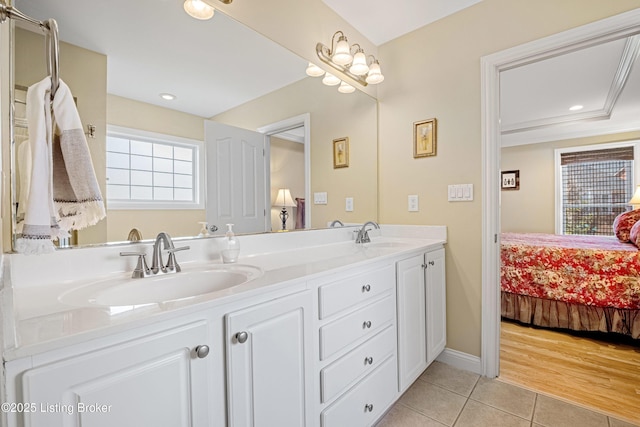 full bath featuring tile patterned flooring, connected bathroom, double vanity, and a sink