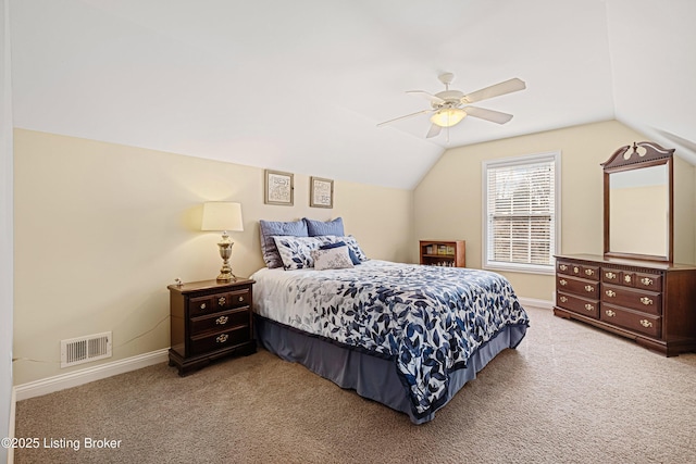 carpeted bedroom featuring visible vents, baseboards, lofted ceiling, and a ceiling fan