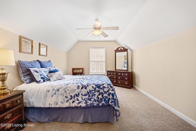 carpeted bedroom with baseboards, ceiling fan, and vaulted ceiling