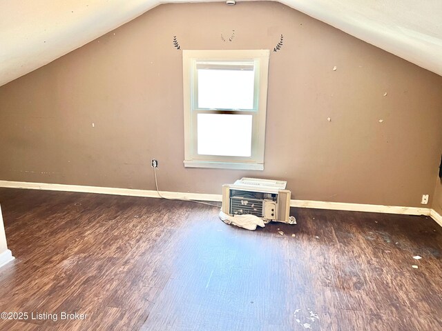 additional living space with vaulted ceiling and wood finished floors