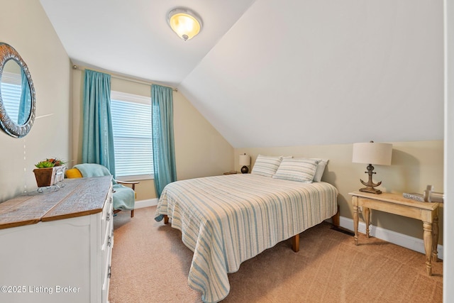 bedroom featuring baseboards, light colored carpet, and vaulted ceiling