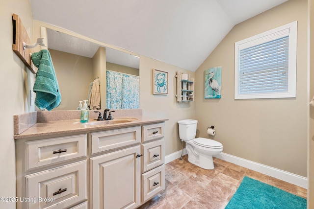 bathroom featuring vanity, baseboards, vaulted ceiling, curtained shower, and toilet