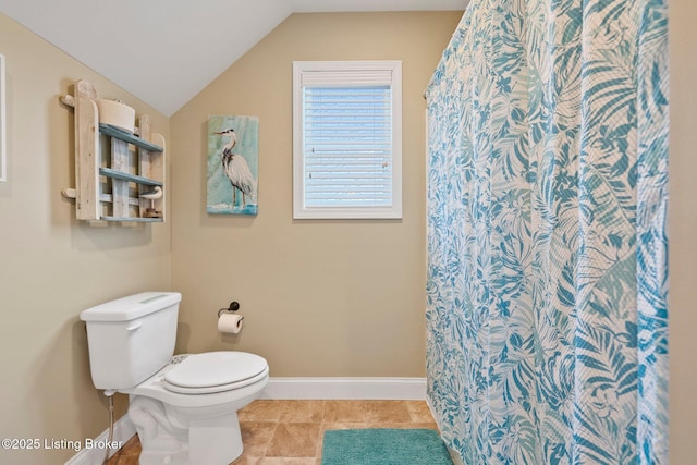 full bath with curtained shower, baseboards, toilet, lofted ceiling, and tile patterned floors