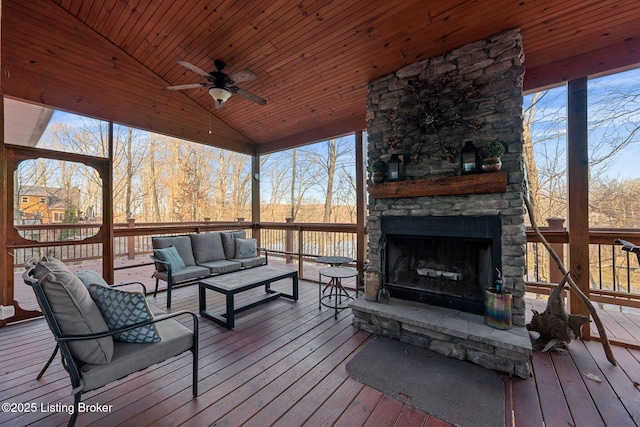 wooden deck with an outdoor living space with a fireplace and ceiling fan