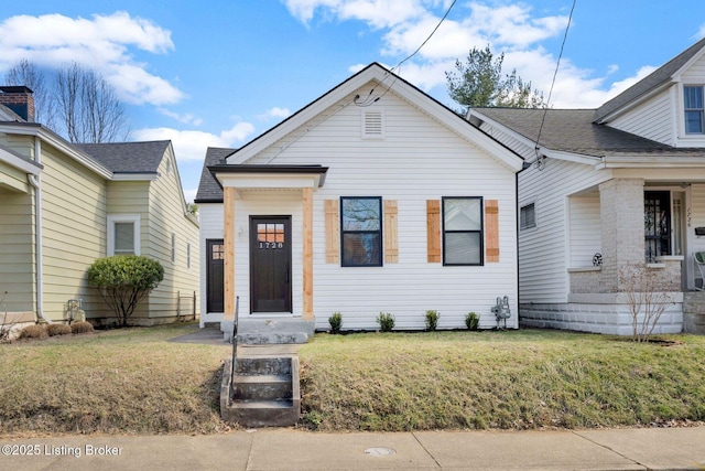 bungalow-style home with a front lawn