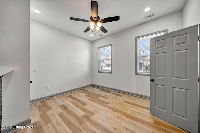 empty room with light wood-style flooring, recessed lighting, baseboards, and visible vents