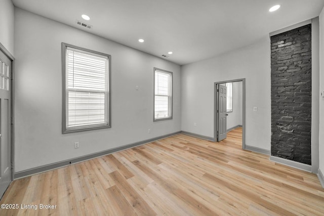 unfurnished room with visible vents, recessed lighting, light wood-type flooring, and baseboards