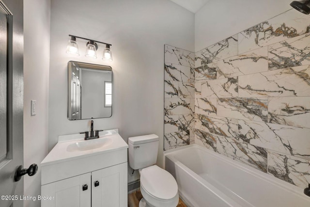 bathroom with toilet,  shower combination, and vanity