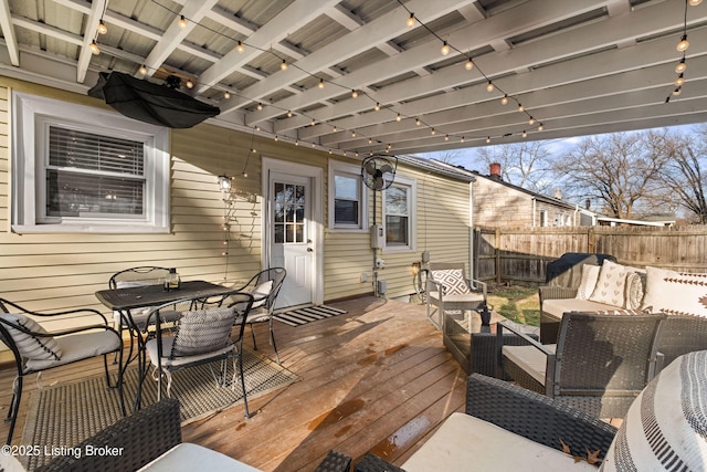 wooden deck featuring outdoor dining space, outdoor lounge area, and fence