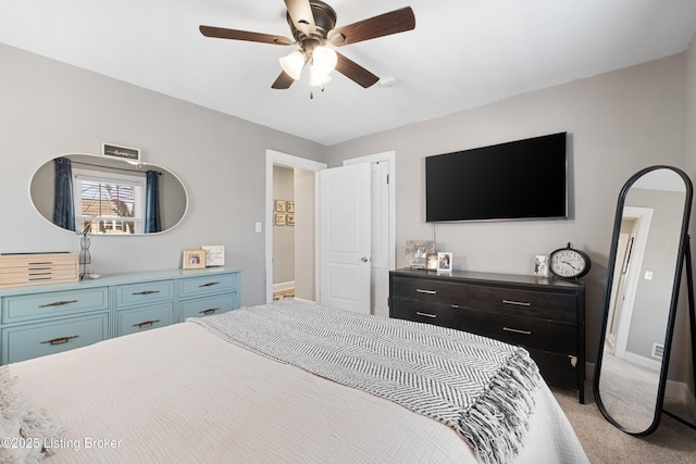 bedroom featuring baseboards, light carpet, and a ceiling fan