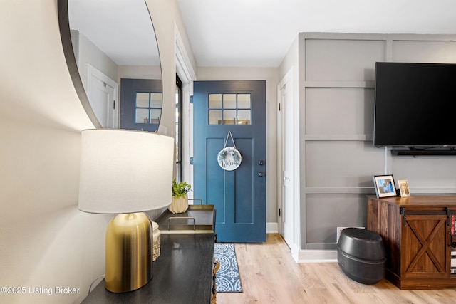 entrance foyer with wood finished floors and baseboards