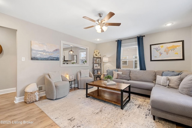 living area featuring a ceiling fan, visible vents, wood finished floors, baseboards, and recessed lighting