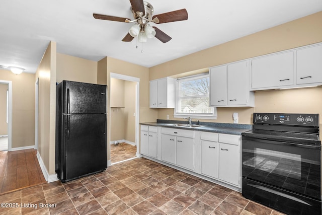 kitchen with black appliances, a ceiling fan, a sink, dark countertops, and white cabinetry