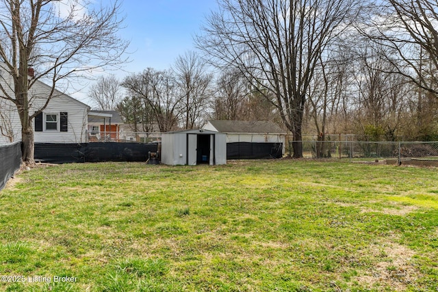 view of yard with an outbuilding, a storage shed, and a fenced backyard