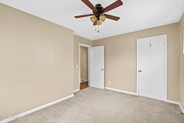 unfurnished bedroom featuring baseboards, carpet floors, and ceiling fan