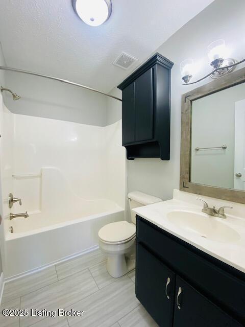 bathroom with visible vents, tub / shower combination, toilet, and vanity