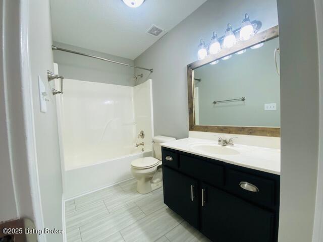 bathroom with visible vents, toilet, shower / bath combination, and vanity