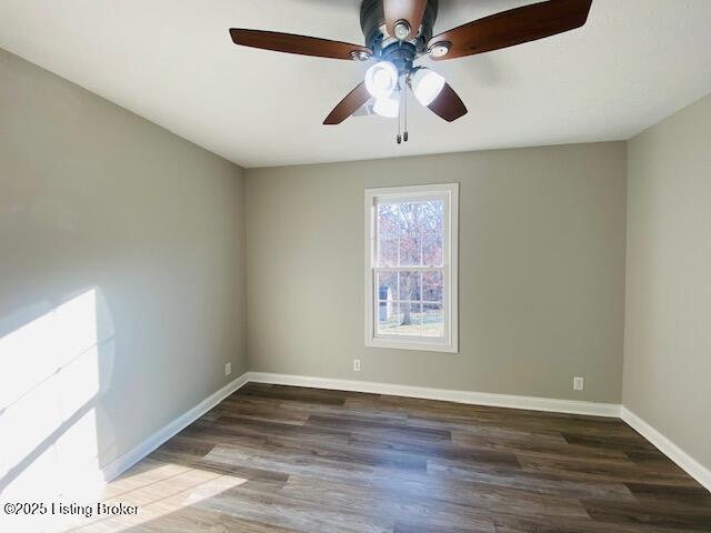 empty room with a ceiling fan, baseboards, and wood finished floors