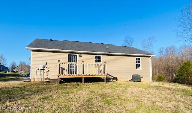 back of house with a deck, a yard, and cooling unit