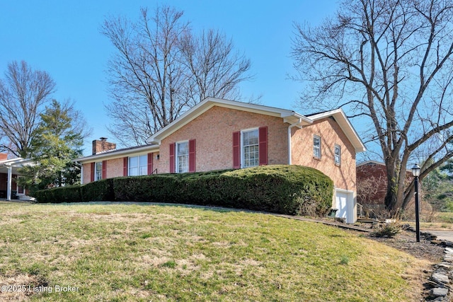 view of front of home featuring brick siding, a chimney, and a front lawn