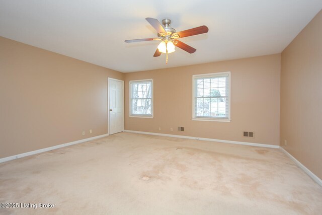 unfurnished room featuring light carpet, visible vents, and baseboards