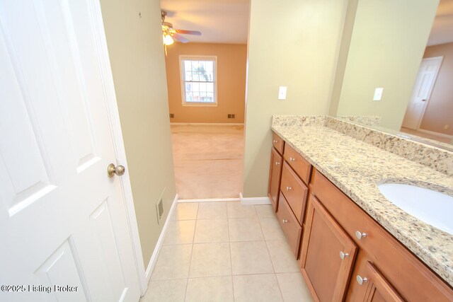 bathroom with vanity, tile patterned floors, baseboards, and ceiling fan