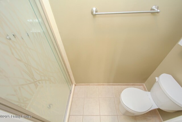 full bathroom with tile patterned floors, toilet, and a shower stall