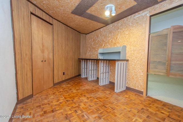 empty room featuring wooden walls