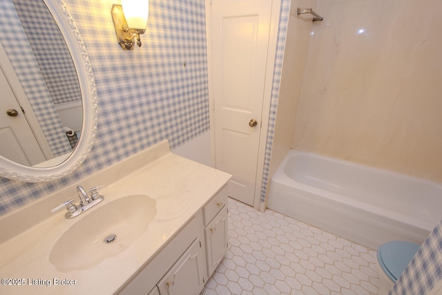 full bathroom with wallpapered walls, tile patterned floors, toilet, and vanity