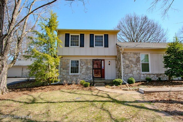 view of front facade featuring stone siding, board and batten siding, and a front lawn