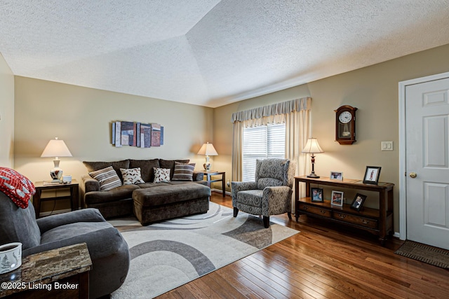 living area with dark wood-style floors and a textured ceiling