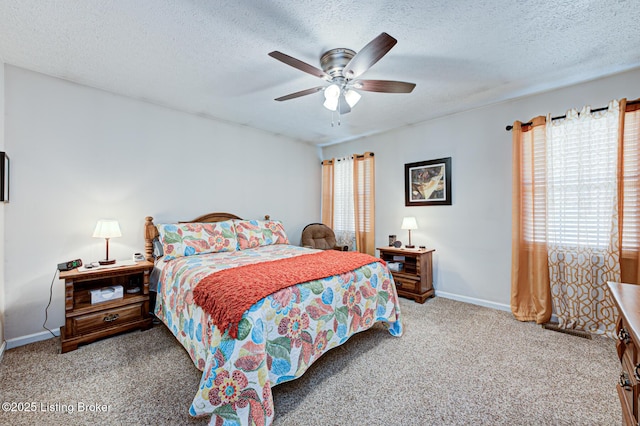 carpeted bedroom featuring a ceiling fan, baseboards, and a textured ceiling