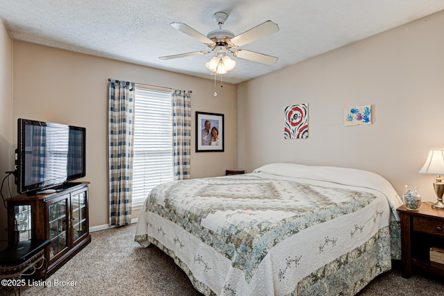 bedroom featuring multiple windows, a textured ceiling, carpet, and ceiling fan