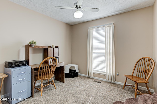 home office featuring a wealth of natural light, visible vents, baseboards, and a ceiling fan